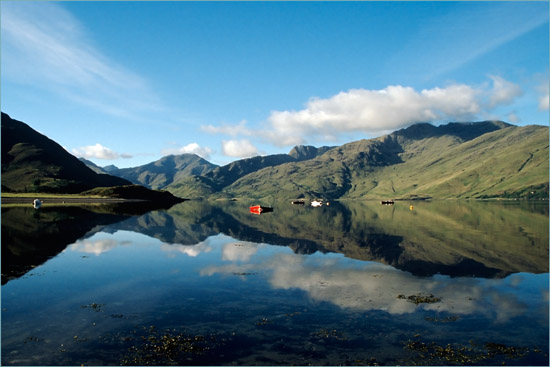 An early morning view of Loch Hourn and Knoydart from Arnisdale, with our wee boat tied to the 'Arnisdale ferry'