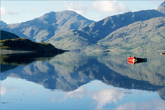 The Arnisdale ferry at its moorings on a tranquil early morning, with our wee ‘Erratic & Fierce’ tied to its side