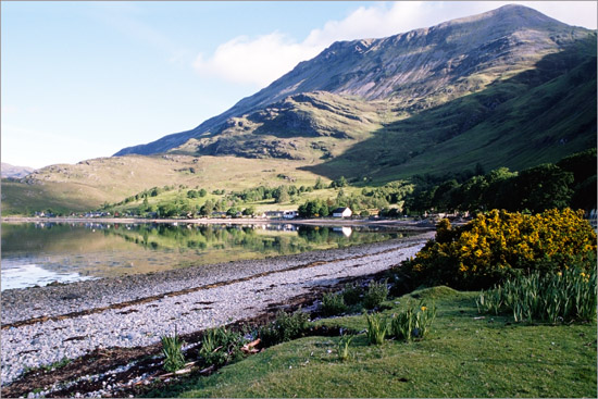 The early morning sun peeping over the hill and touching Arnisdale