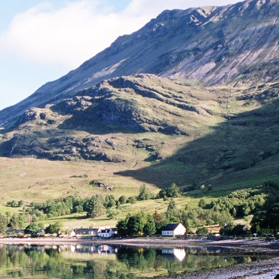 Zoom: The early morning sun peeping over the hill and touching Arnisdale