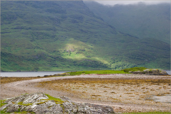 A spot of sunlight on the foot of Creag Bheithe of the Ladhar Bheinn system, as seen over Eilean Choinnich, or Cemetery Island, at Barisdale