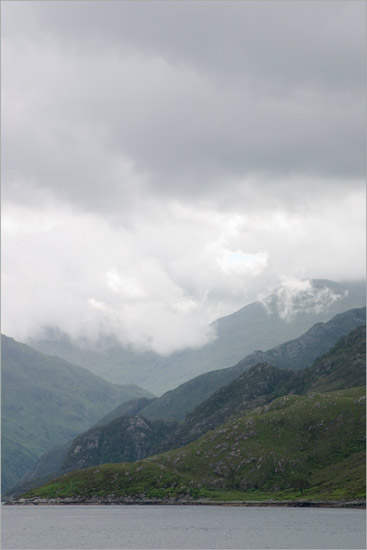 Clouds churning around Sgurr a’ Mhaoraich behind inner Loch Hourn; light rising from Coire Sgoireadail