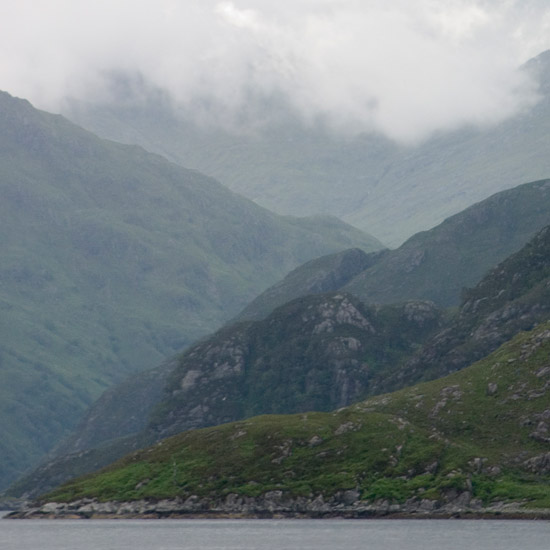 Zoom: Clouds churning around Sgurr a’ Mhaoraich behind inner Loch Hourn; light rising from Coire Sgoireadail
