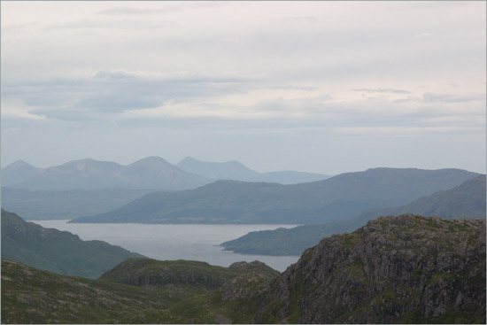 A distant view of the isle of Skye from Slat Bheinn, with An Caisteal in the foreground