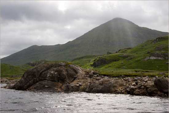 The bleak shore of Loch Quoich on a wild day; paltry sunbeams slipping down from over Sgurr Mòr