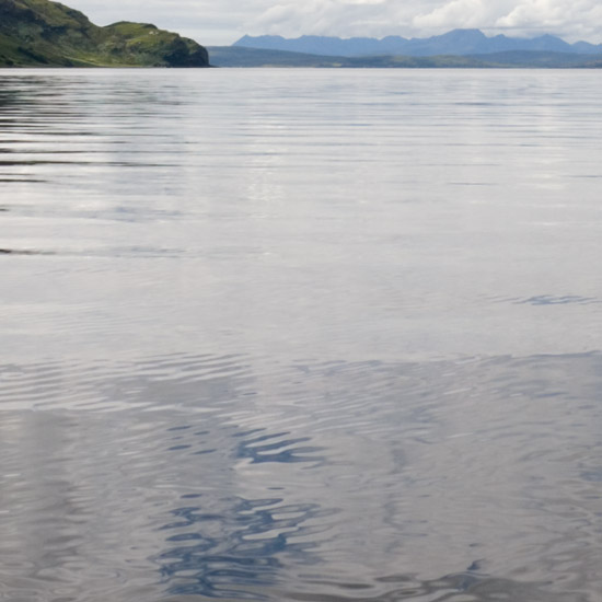 Zoom: Loch Hourn smooth and shivering, the Cuillins smoking in the distant West